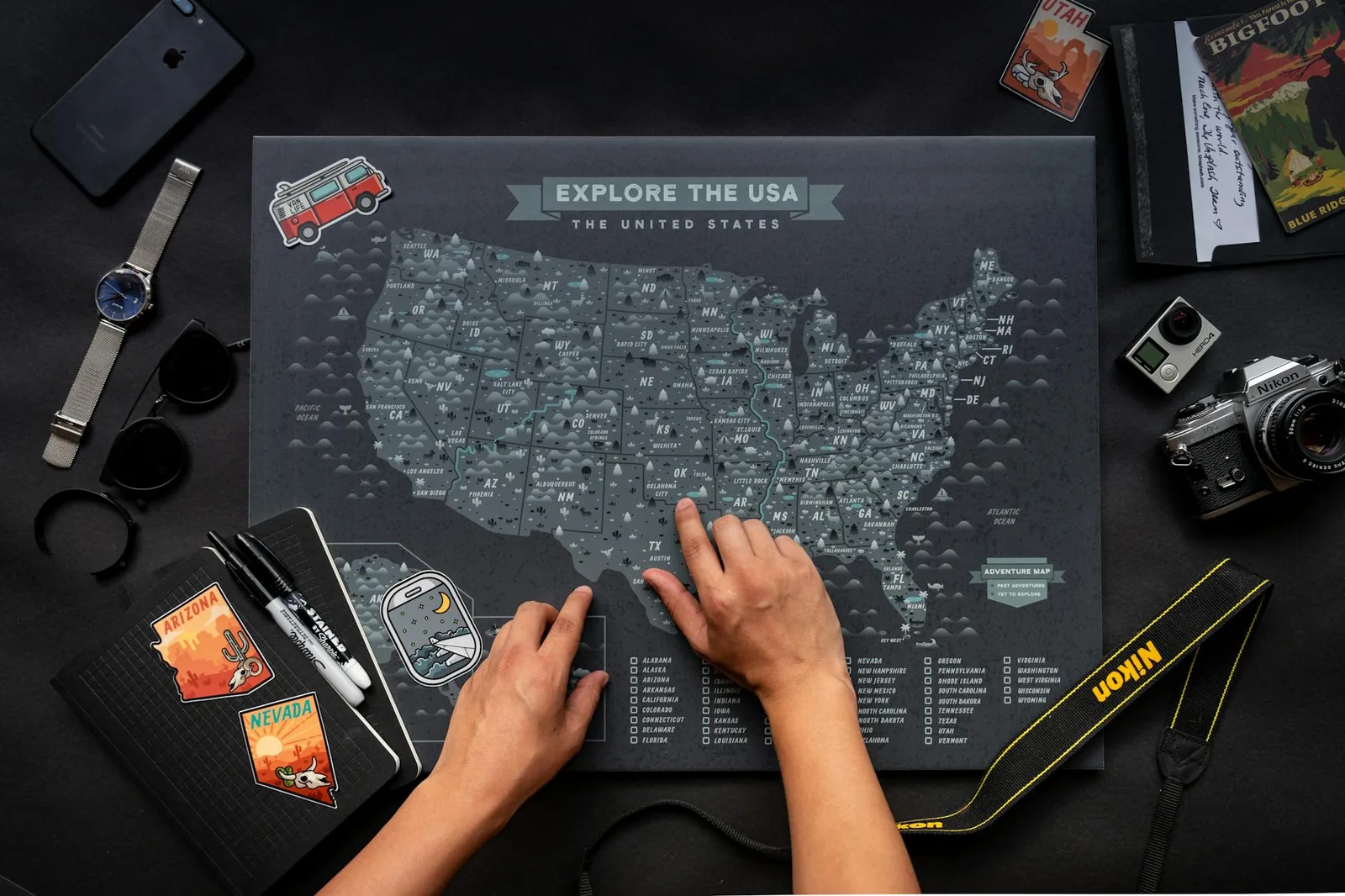 Traveler checking a map of the United States to plan a cross-state trip.