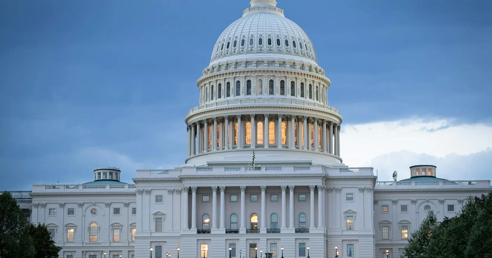 United States Capitol dome at dusk under a fading sky.