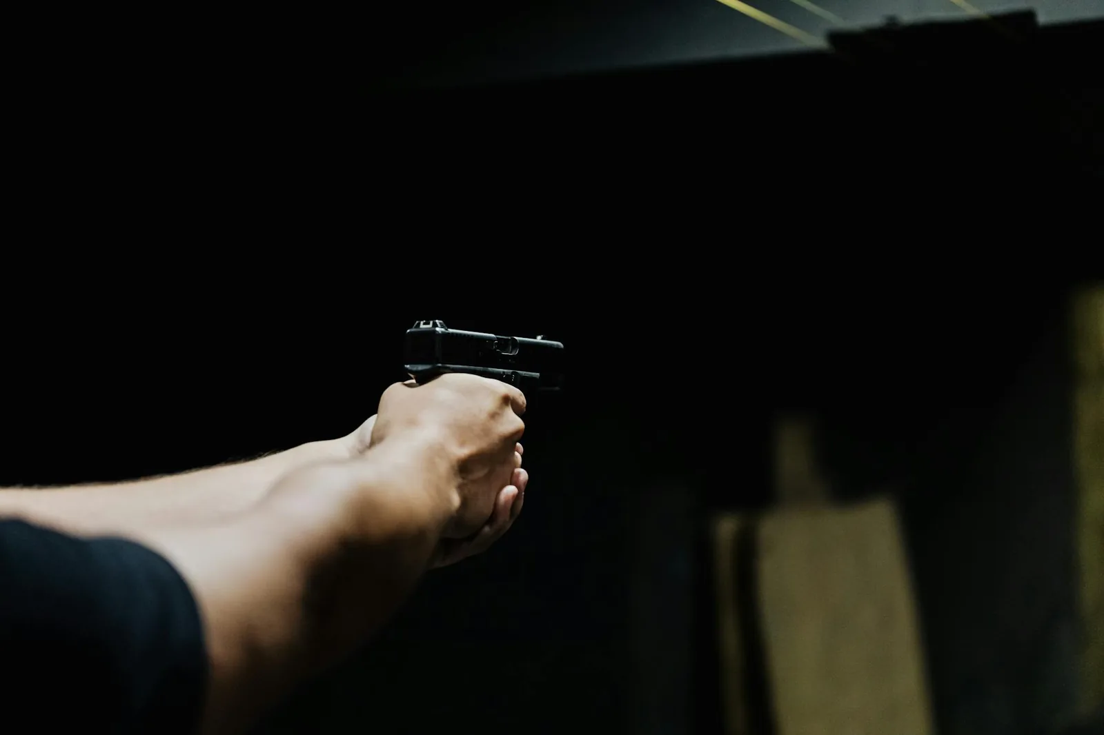 New shooter practicing proper handgun grip and stance during firearm training.
