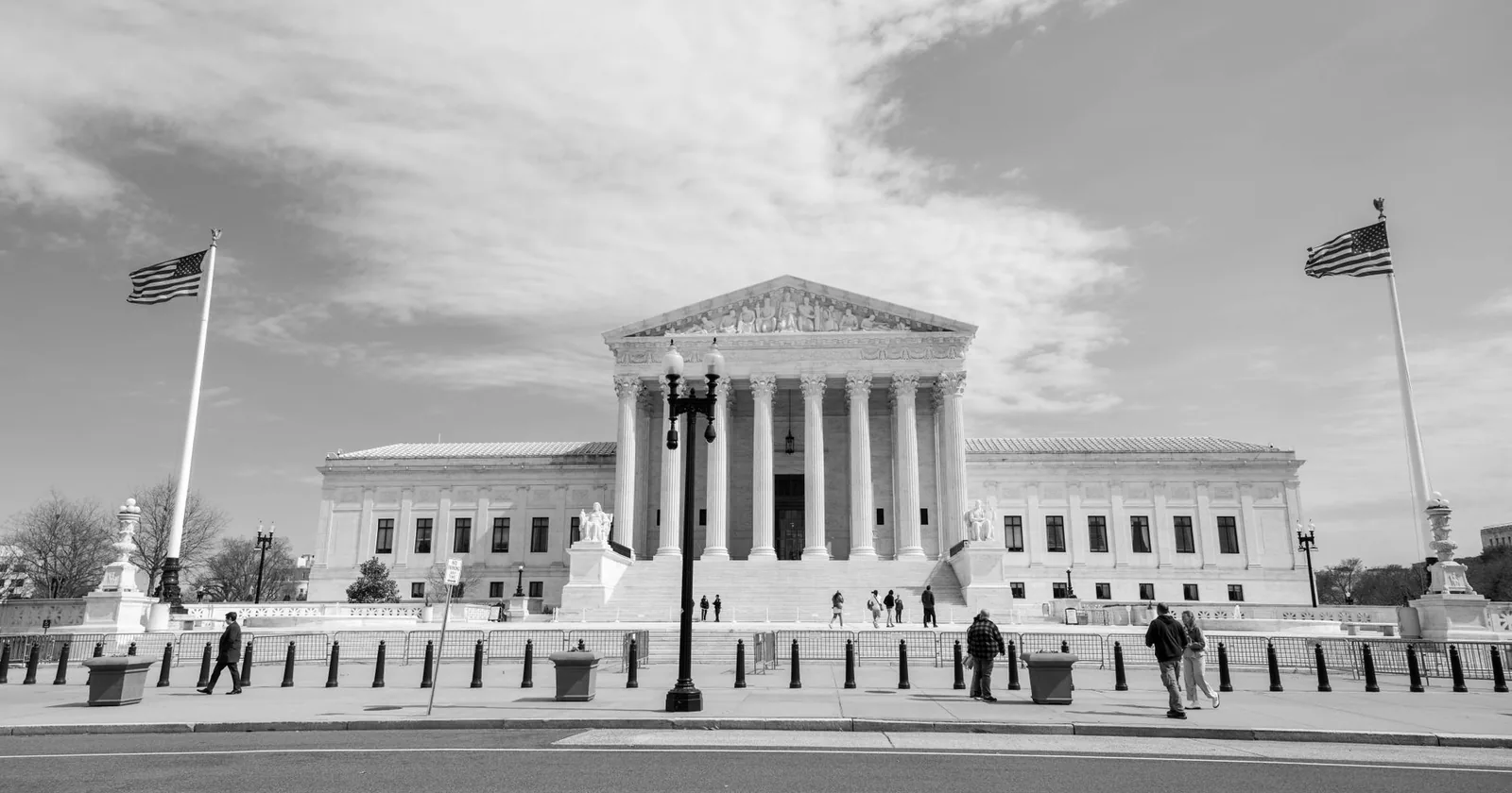 The United States Supreme Court building in Washington, DC, photographed in black and white from across the street.
