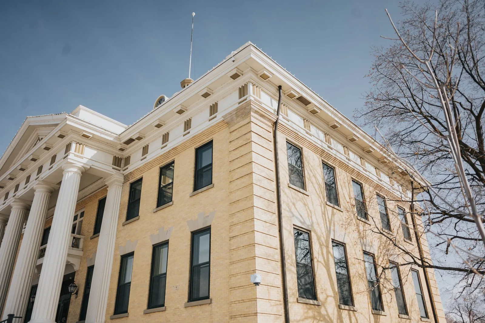 A brick county courthouse with white columns